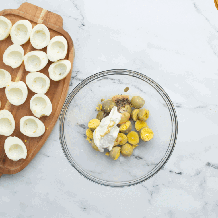 In a large mixing bowl, make the filling for the Gluten Free Deviled Eggs.