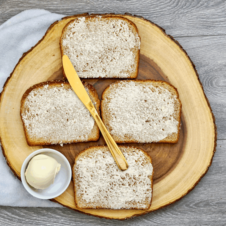Using a sharp knife butter the bread on both sides.