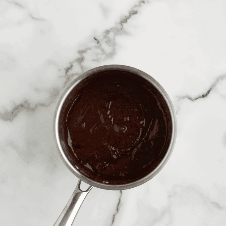 BBQ sauce, honey, and hot sauce combined in a saucepan before heating
