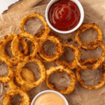 Plate of crispy, golden Hooters-style onion rings ready to serve.