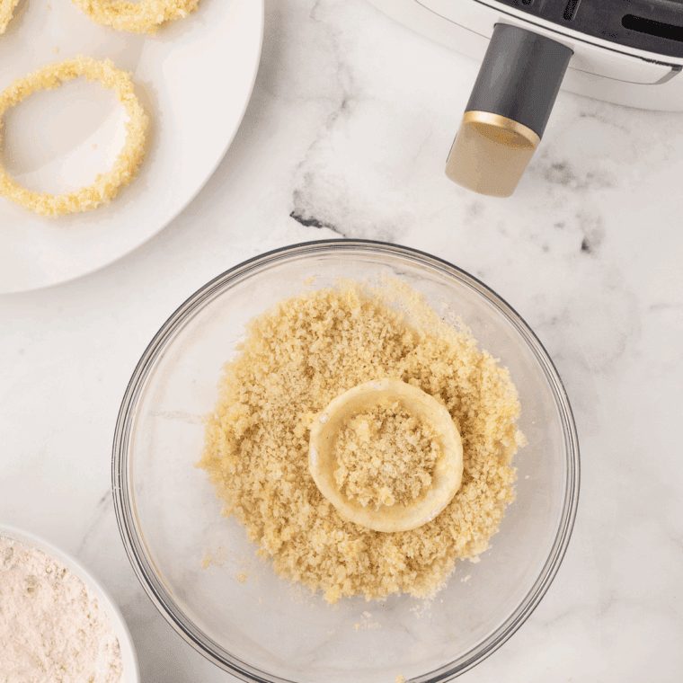 Dip each onion ring in dry mixture, then egg, then panko breadcrumbs, pressing lightly to adhere.