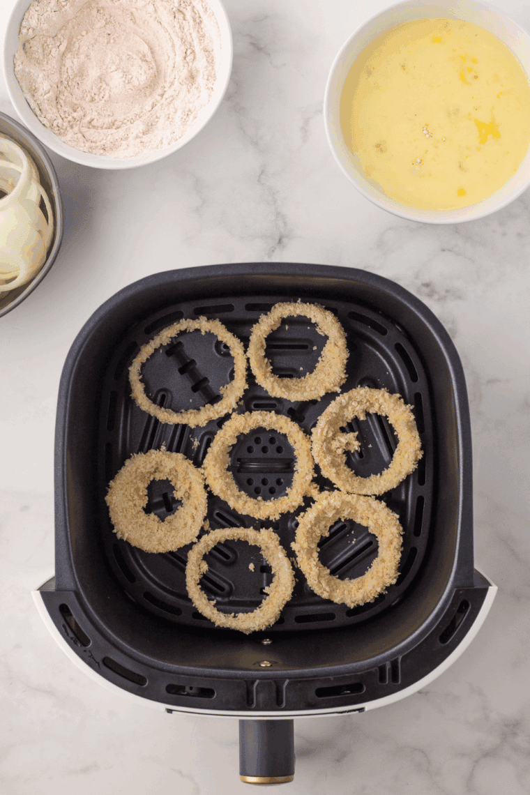 Air fry onion rings at 375°F in a single layer for 8–10 minutes until golden brown, flipping halfway, serve with dipping sauce.