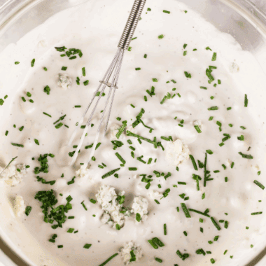 Ina Garten Buttermilk Blue Cheese Dressing served in a bowl with salad on the side.