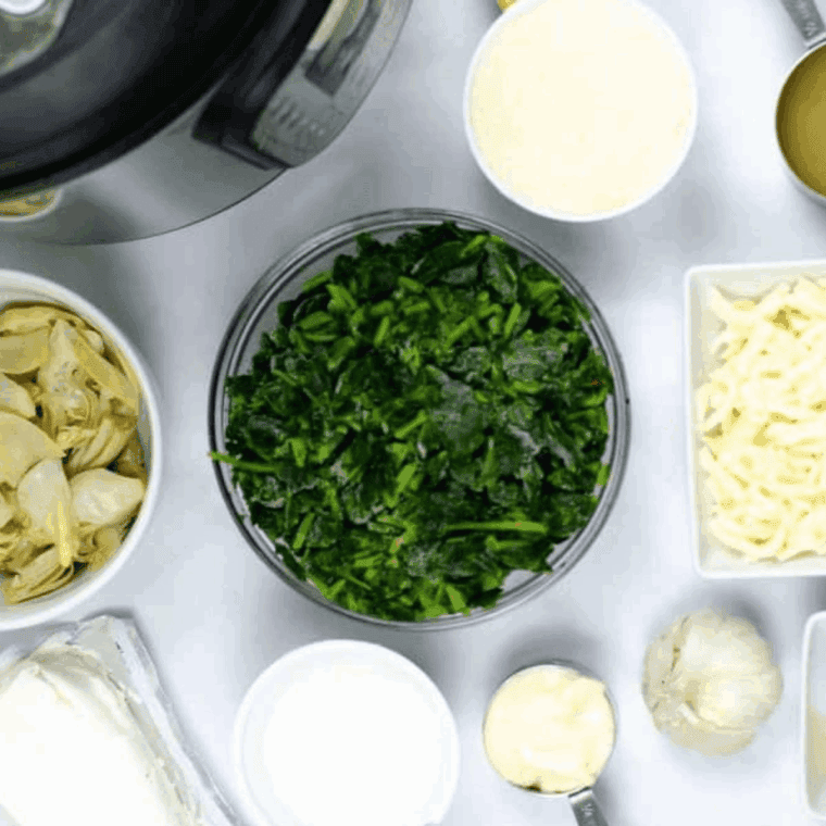 Ingredients needed for Ina Garten Spinach Artichoke Dip Recipe on kitchen table.