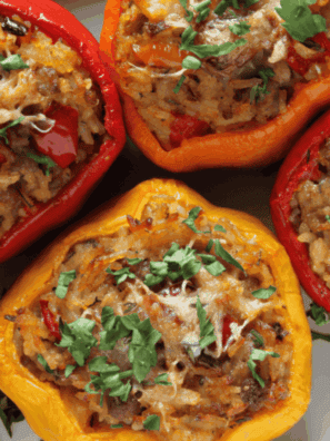Ina Garten stuffed peppers baked with ground beef, rice, herbs, and melted cheese in a baking dish.