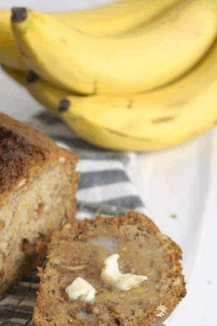 Sliced Ina Garten banana bread loaf, golden brown with soft, moist interior and chopped toasted pecans.