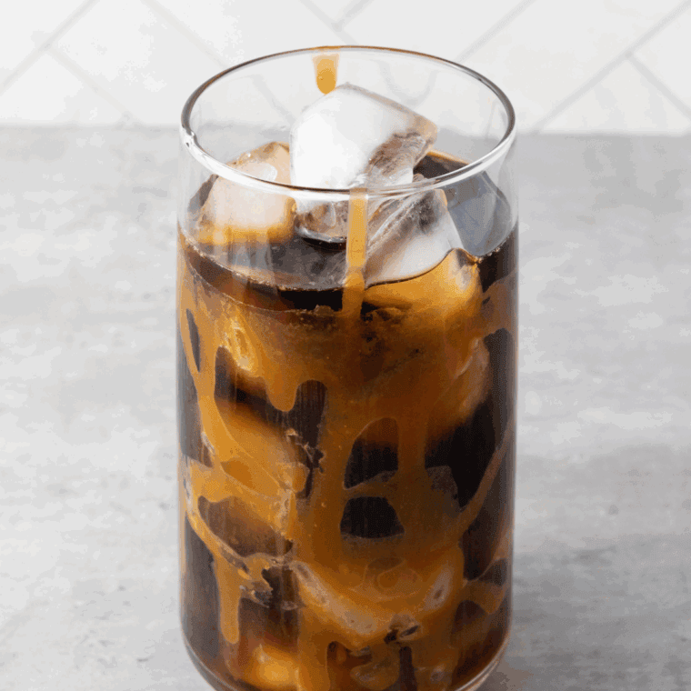 Blending ice, coffee, milk, condensed milk, and syrup for a smooth homemade Creamaccino.