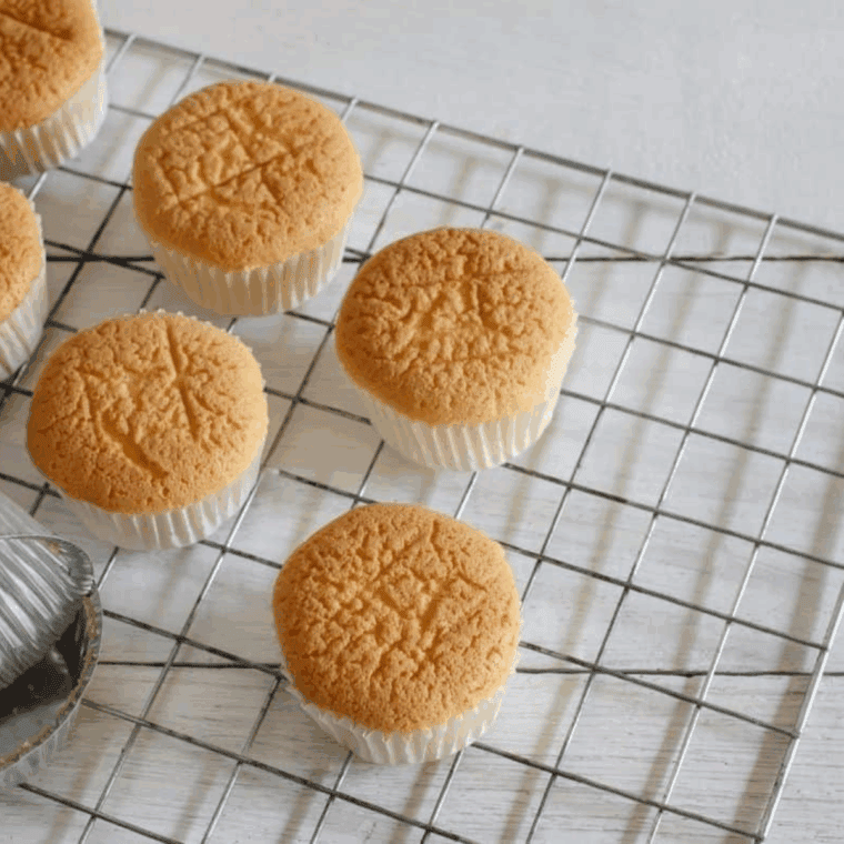 Letting From Scratch Lemon Raspberry Cupcakes in the cool on a wire rack.