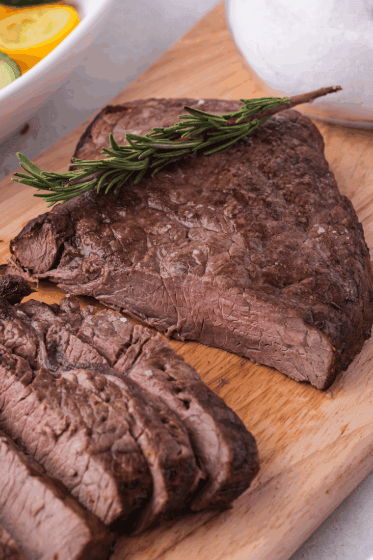 Air fryer Longhorn Renegade Sirloin steak, golden brown and juicy, served with fresh herbs.