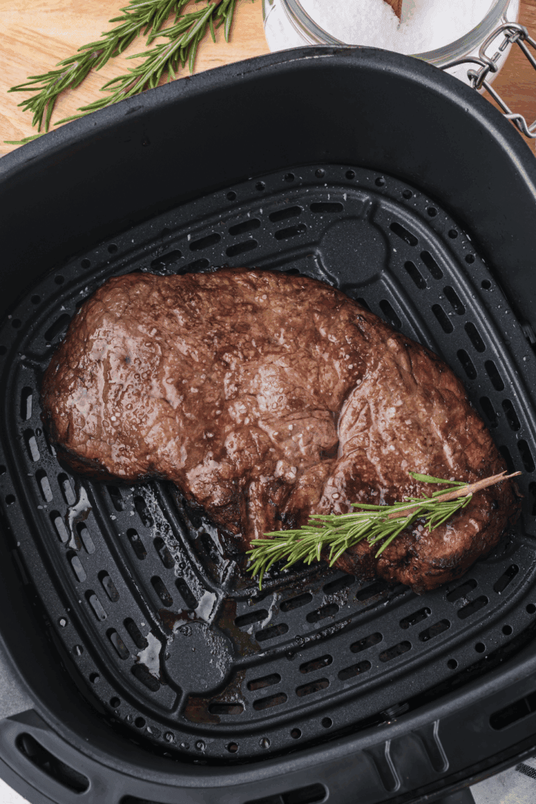 Air fryer Longhorn Renegade Sirloin steak, cooked to perfection and garnished with fresh herbs.