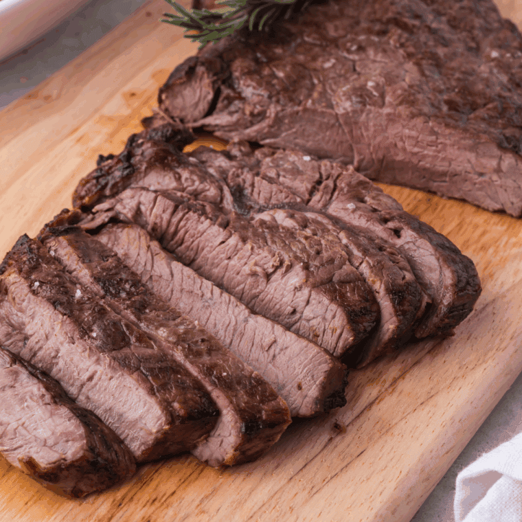 Air fryer Longhorn Renegade Sirloin steak, golden brown and juicy, served with fresh herbs.