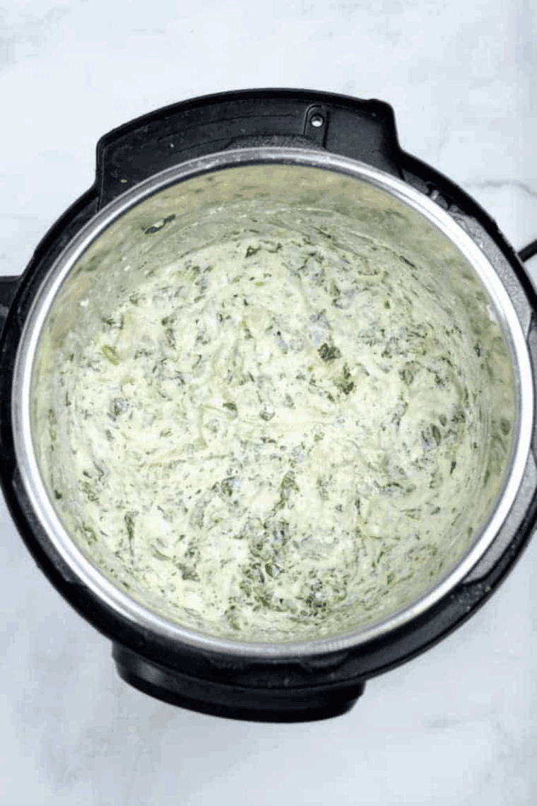 Homemade Longhorn Steakhouse copycat Parmesan crusted spinach dip served hot with chips and bread for dipping