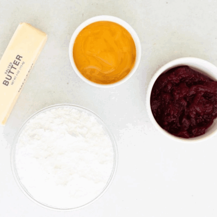 Ingredients needed for Raspberry Frosting With Jam on kitchen table.