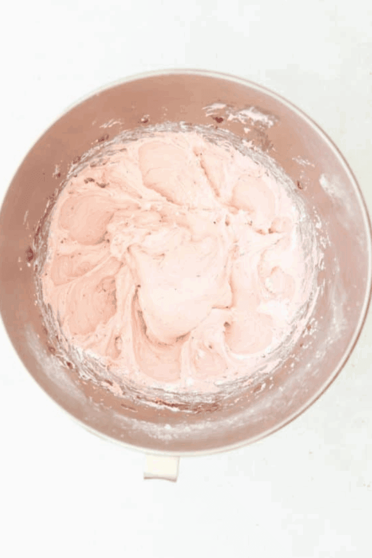 Blend Raspberry Frosting With Jam ingredients in a large mixing bowl.