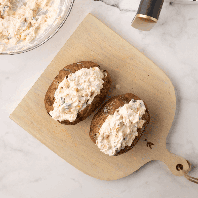 Creamy potato filling spooned back into shells, topped with cooked shrimp and melted cheese.