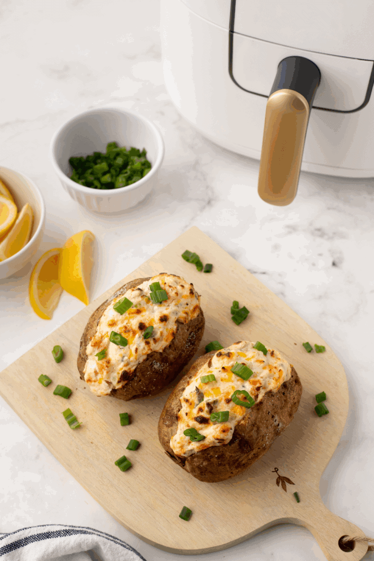 Baked potato stuffed with creamy cheese filling and topped with seasoned shrimp and fresh herbs.