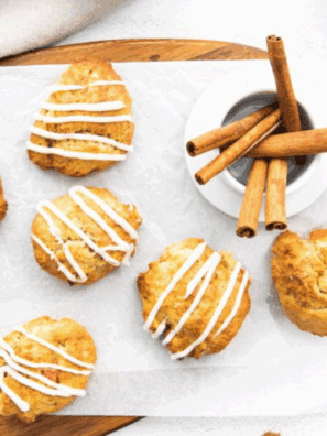 Golden brown sourdough apple fritters topped with glaze on a wire rack