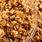 Homemade nut-free granola baked until golden, served in a bowl with oats, seeds, and dried fruit.