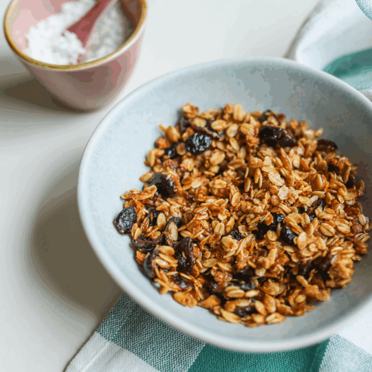 Golden-baked nut-free granola with oats, seeds, and dried fruit in a bowl.