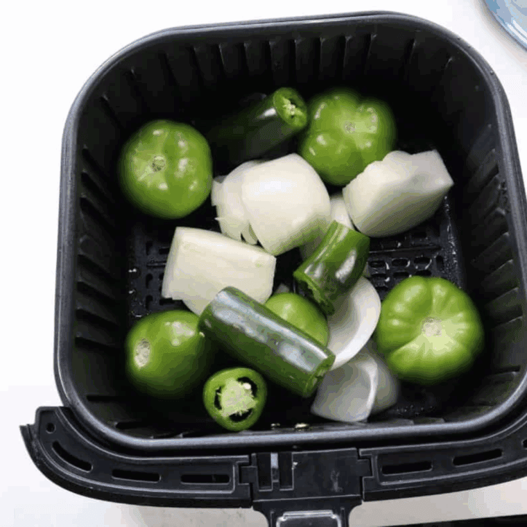 Cook the tomatoes, diced onions and garlic in an air-frying basket until lightly charred and softened.