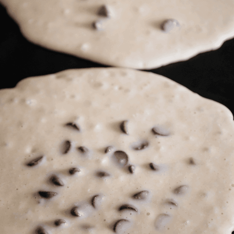 Close up of Banana Chocolate Chip Air Fryer Pancakes in the air fryer basket.