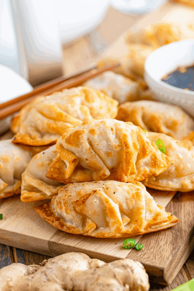 Homemade Benihana-style Gyoza dumplings, golden brown and served with dipping sauce.