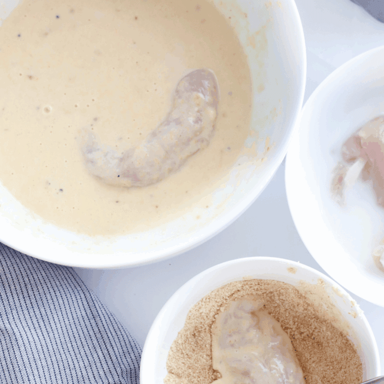  Set up three bowls for dipping chicken in the seasoned flour mixture, beaten egg and bread crumbs.