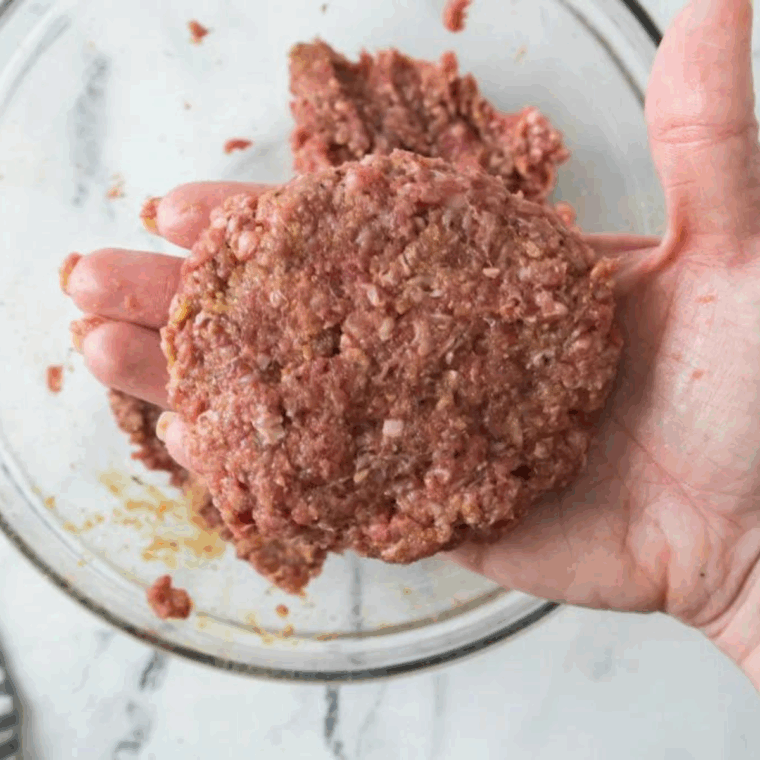 Salt and pepper beef patties, lightly oiled and seasoned.
