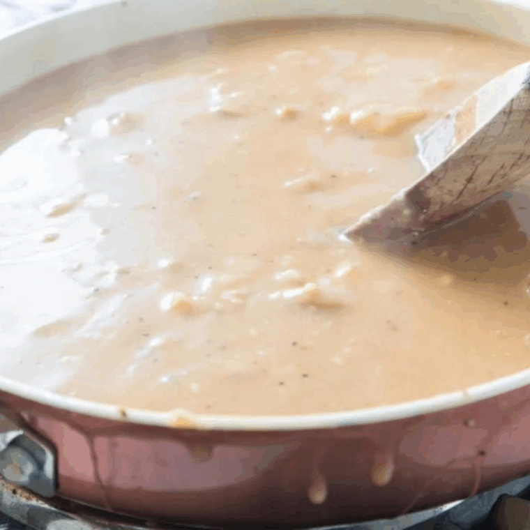 Rich onion and mushroom gravy poured over air-fried chopped steaks, served with mashed potatoes and vegetables.