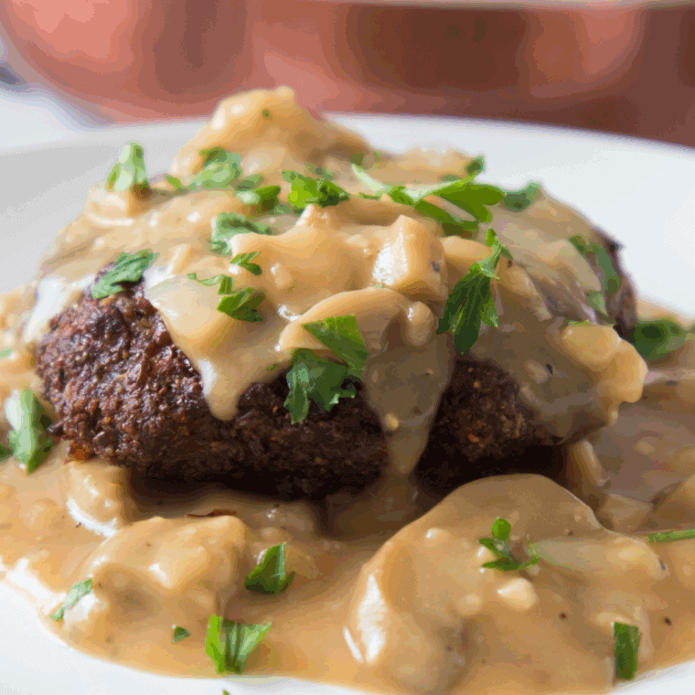 Plate of Bob Evan's Mushroom and Onion Chopped Steak Recipe with sauce on top of the steak.