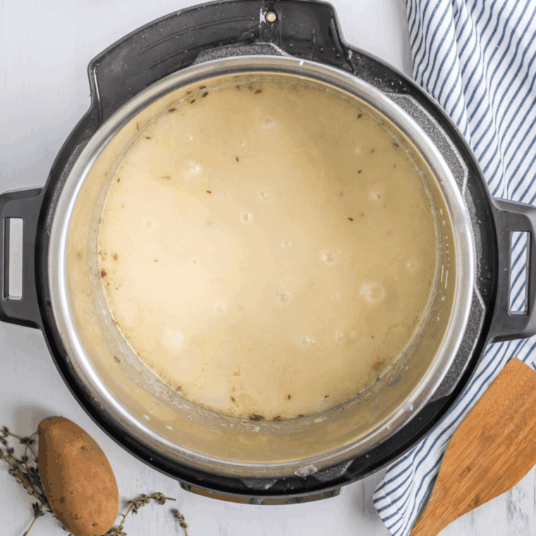 Combine cheddar cheese soup, chicken broth, and milk in a bowl; stir until smooth and creamy.