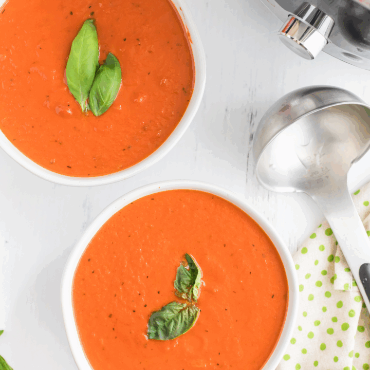 Bowl of creamy copycat Jason’s Deli tomato soup garnished with basil