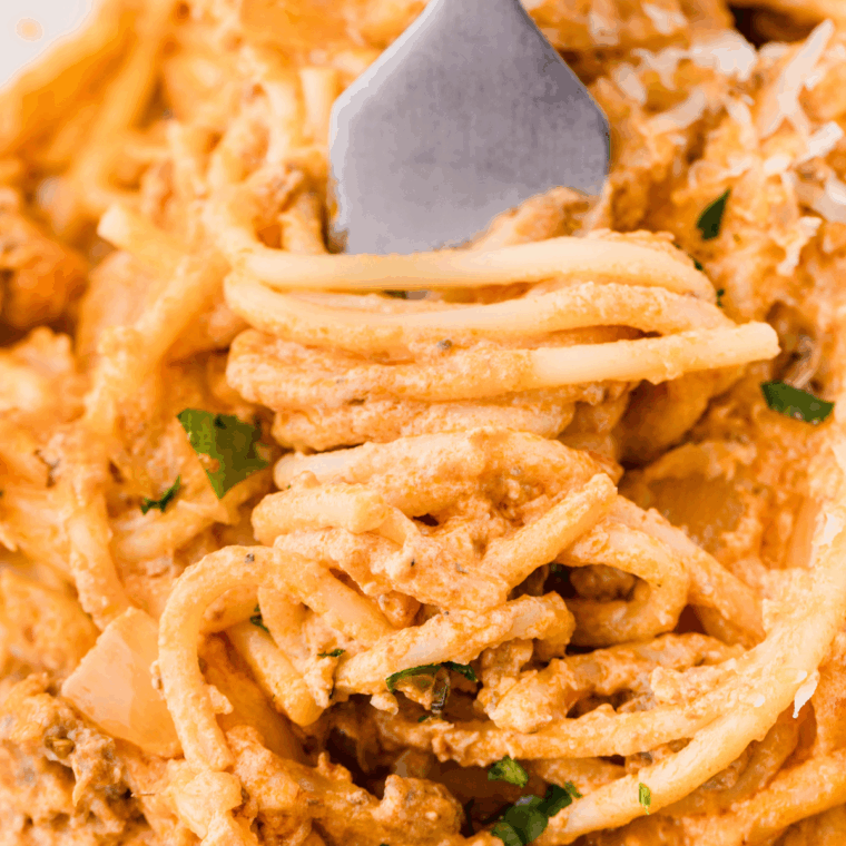 Crockpot Million Dollar Pasta with melted cheese, ground beef, and marinara sauce in a slow cooker.