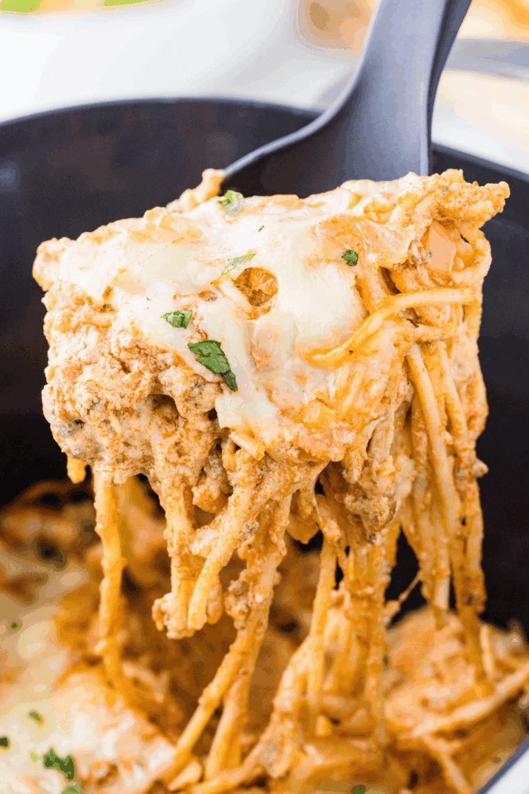 Crockpot Million Dollar Pasta with melted cheese, ground beef, and creamy sauce served in a slow cooker.