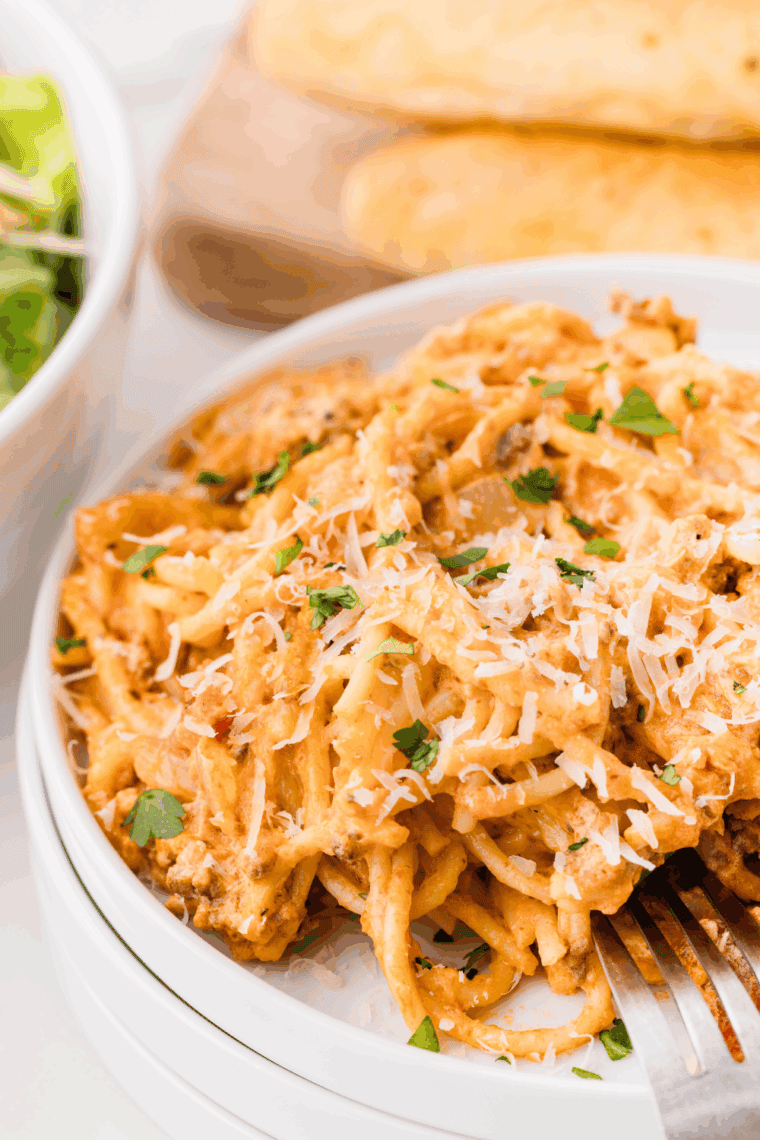 Crockpot Million Dollar Pasta with melted cheese, ground beef, and creamy sauce in a slow cooker.