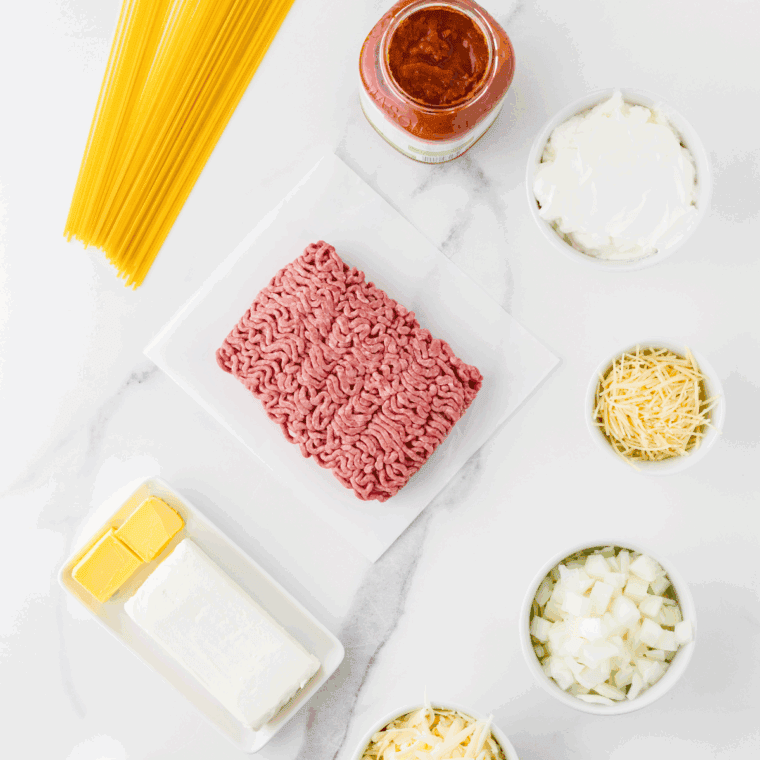 Ingredients needed for Crockpot Million Dollar Pasta on kitchen table.