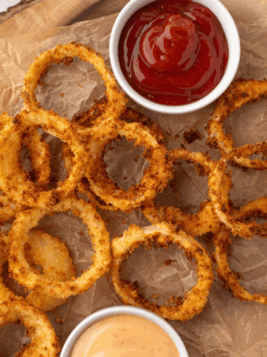 Golden crispy homemade Dairy Queen-style onion rings served with dipping sauce