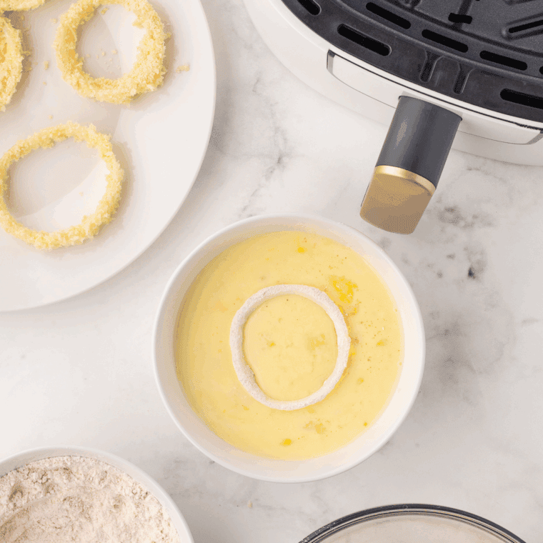 Onion rings dipped in batter and coated with panko breadcrumbs.