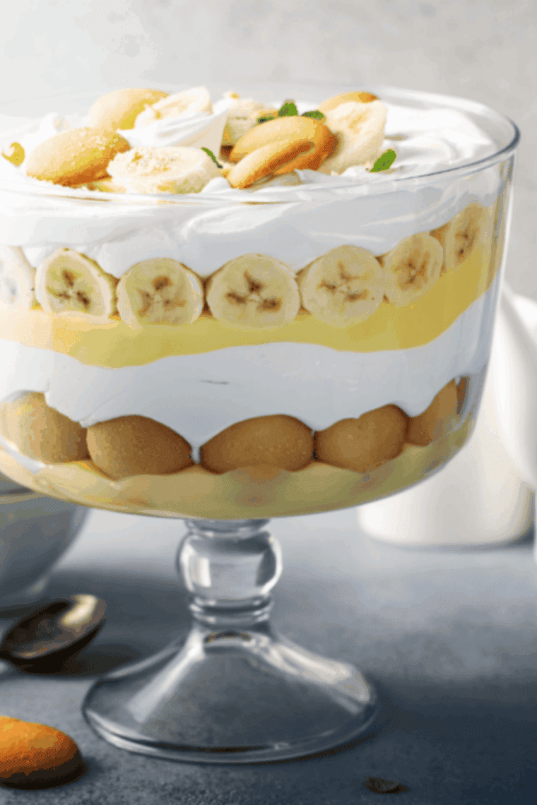 Golden Corral banana pudding in a glass dish with vanilla wafers and fresh bananas in between layers.
