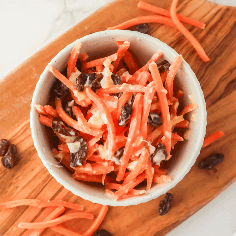 Bowl of Golden Corral Carrot and Raisin Salad on kitchen counter.