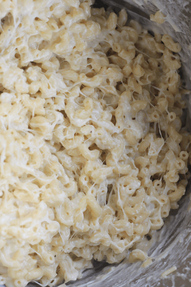 Adding shredded cheddar, Colby and cream cheese into the Instant Pot Sauce, stir until well combined.