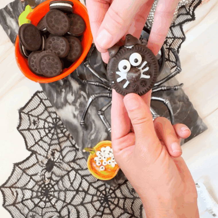 Plate of Halloween Black Cat Oreo Cookies on kitchen table.
