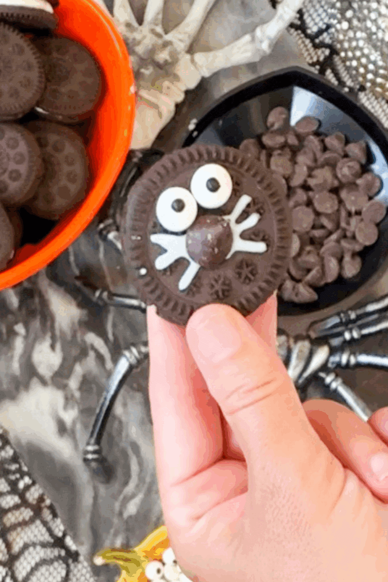 Adding the eyes onto the Oreo Cookie in the kitchen table.