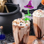 Colorful Hocus Pocus milkshake topped with whipped cream and sprinkles.