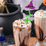Colorful Hocus Pocus milkshake topped with whipped cream and sprinkles.