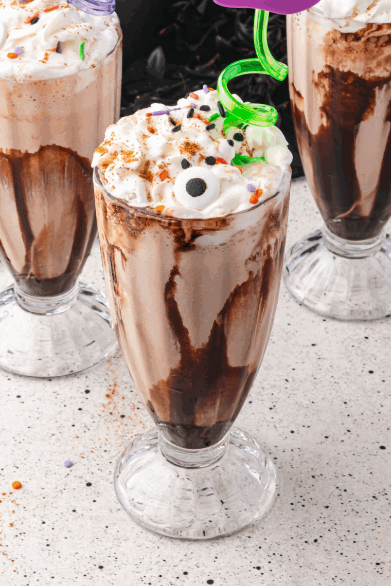 Colorful Hocus Pocus milkshake topped with whipped cream and Halloween sprinkles.