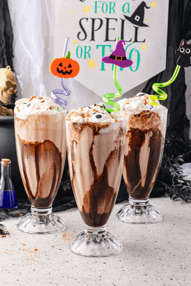 Colorful Hocus Pocus milkshake topped with whipped cream and Halloween sprinkles.