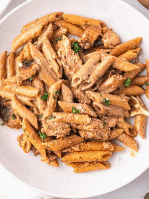 Homemade Cajun Alfredo sauce served over creamy pasta with a sprinkle of parsley.