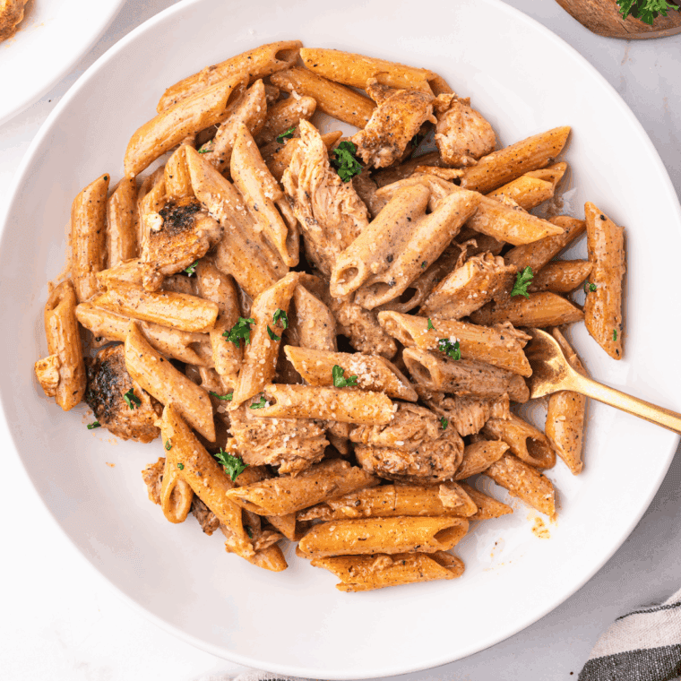 Homemade Cajun Alfredo sauce served over creamy pasta with a sprinkle of parsley.