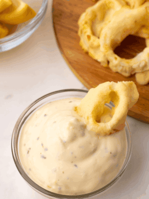 Homemade Ina Garten tartar sauce served in a bowl with lemon and dill garnish.